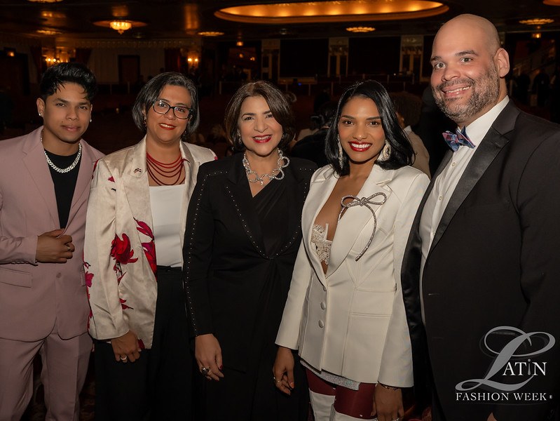 A group of five guests posing together inside the event venue