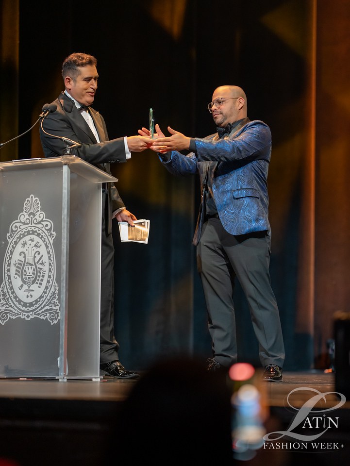 An award is presented onstage beside the ceremony podium